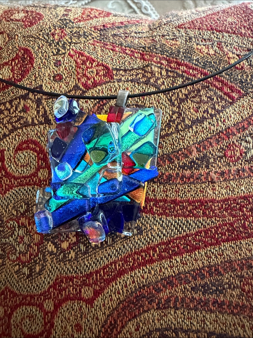 Glass pendant abstract of colored glass fired together
